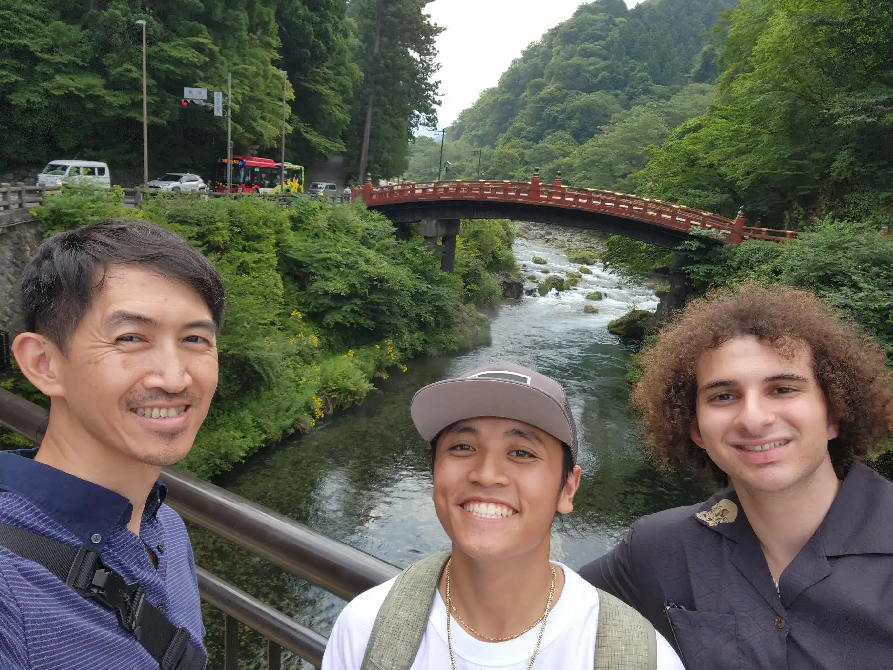 Chen, Pascua, and Ezzeddine take a selfie on a bridge in Japan.